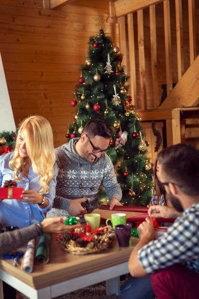 istock Friends wrapping Christmas gifts 1169731502