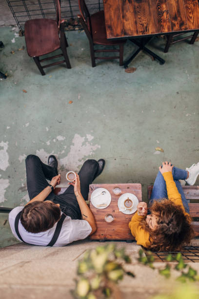 istock Couple sitting in sidewalk cafe 1169731553