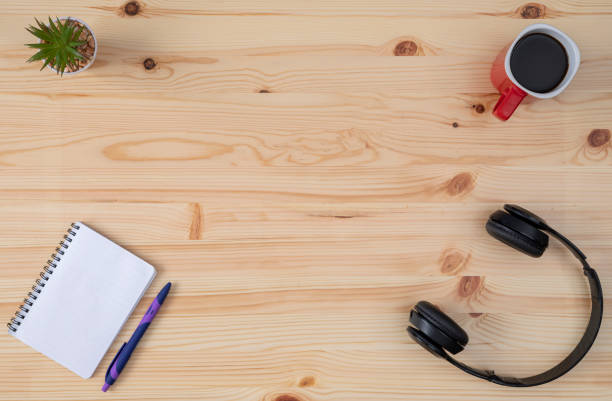 Desk with headphones, agenda and coffee