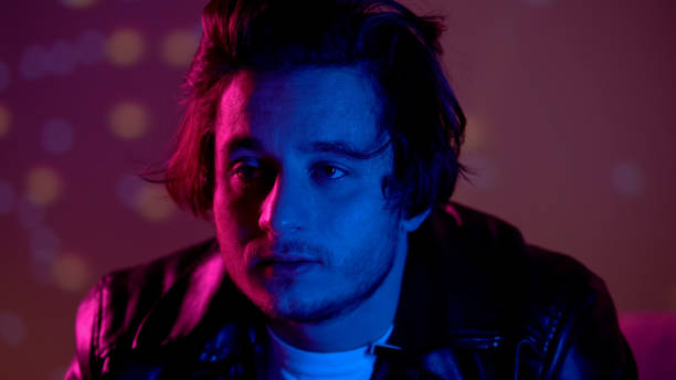 istock Depressed man relaxing on party in night club, thinking over life problems 1169733556