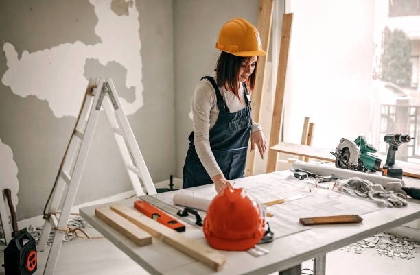 istock Woman analyzing blueprint for her new home interior 1169735158