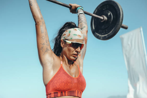 istock Strong and confident female athlete working out on the beach 1169735947