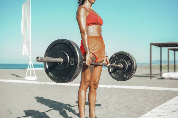 istock Strong and confident female athlete working out on the beach 1169735963