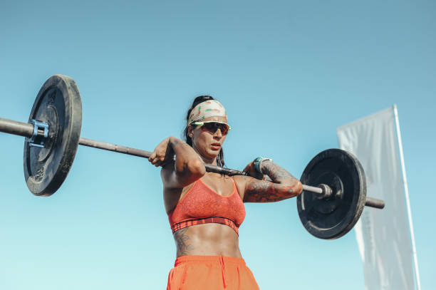 istock Strong and confident female athlete working out on the beach 1169735972
