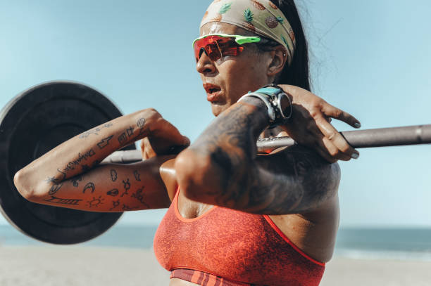 istock Strong and confident female athlete working out on the beach 1169735996