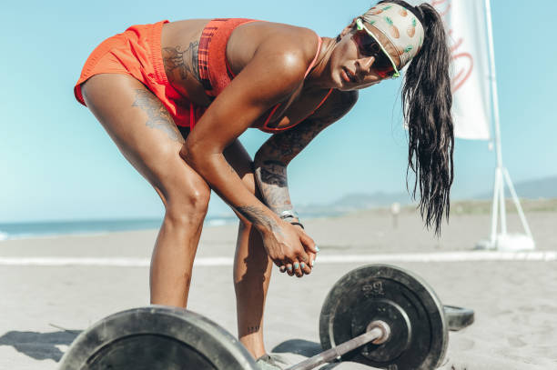 istock Strong and confident female athlete working out on the beach 1169736004