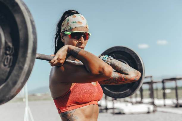 istock Strong and confident female athlete working out on the beach 1169736052