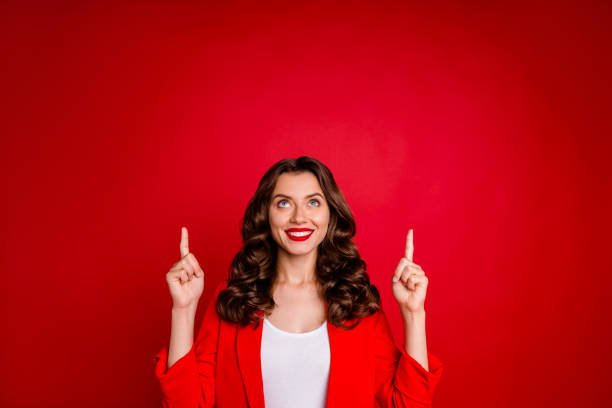 istock Amazing lady indicating empty space on black friday prices dressed formal-wear costume isolated burgundy background 1169738774