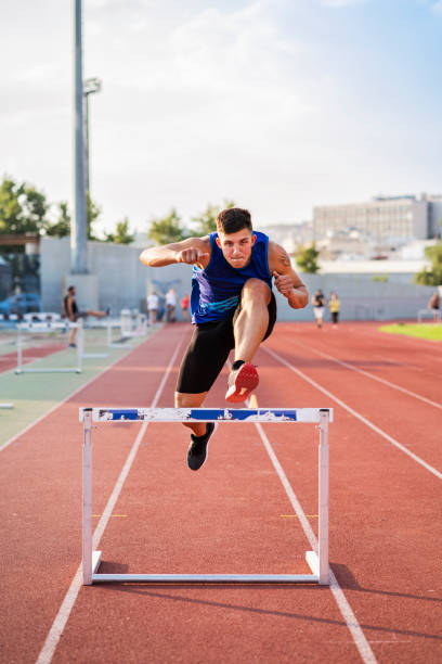 istock Athlete Man Preparing And Runs Hurdles for Track and Field 1169739036