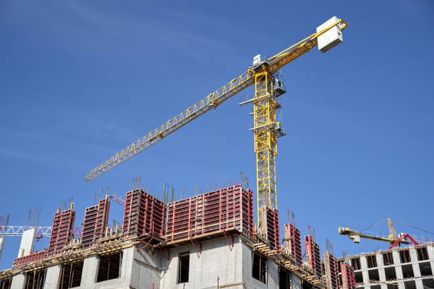 Construction site, building a new houses, crane, blue sky.