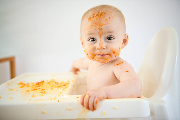 istock A Little baby eating her dinner and making a mess 1169745441