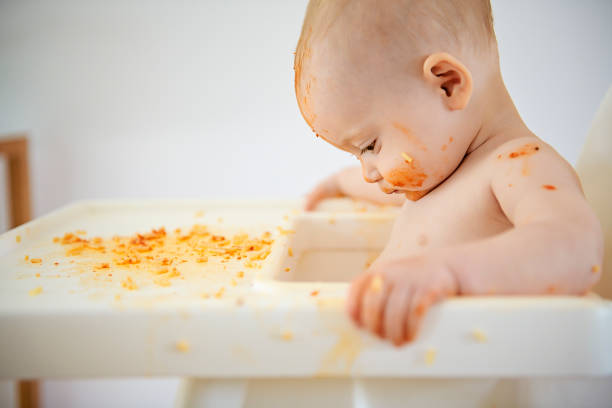 istock A Little baby eating her dinner and making a mess 1169745443