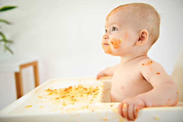 istock A Little baby eating her dinner and making a mess 1169745459