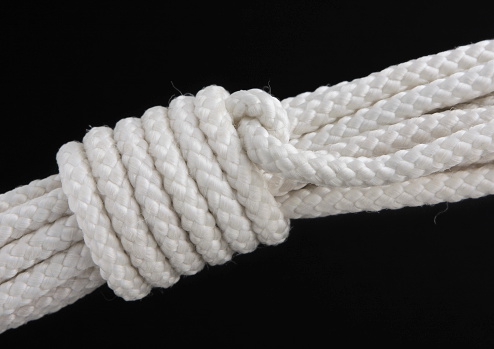 A mountain coil rope knot used to secure climbing rope during transport to prevent tangling.  The mountaineer's coil (also alpine coil, climber's coil, lap coil, or standing coil) is a traditional method used by climbers to store and transport a climbing rope without tangling.