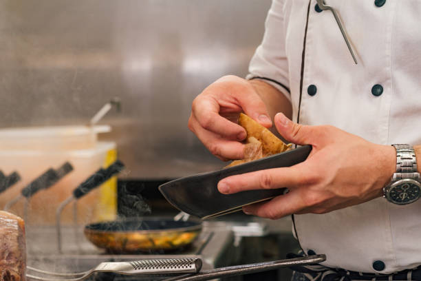 istock Close-up image of chef holding bowl and potato, copy space. 1169747993