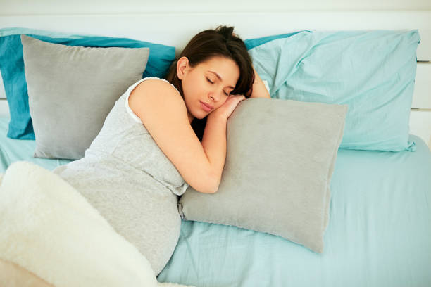 istock Pregnant woman sleeping. 1169751273