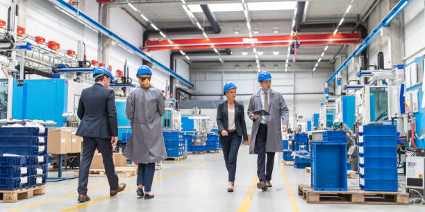 istock Engineer and company manager walking through a factory 1169752611