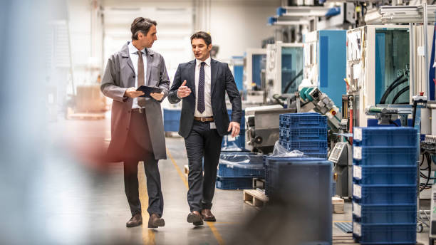 istock Engineer walking and talking with factory manager 1169752621
