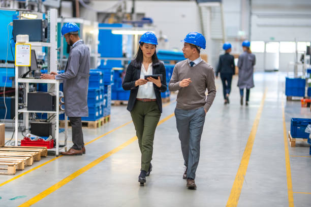 istock Two engineers walking through an automated factory and talking 1169752623
