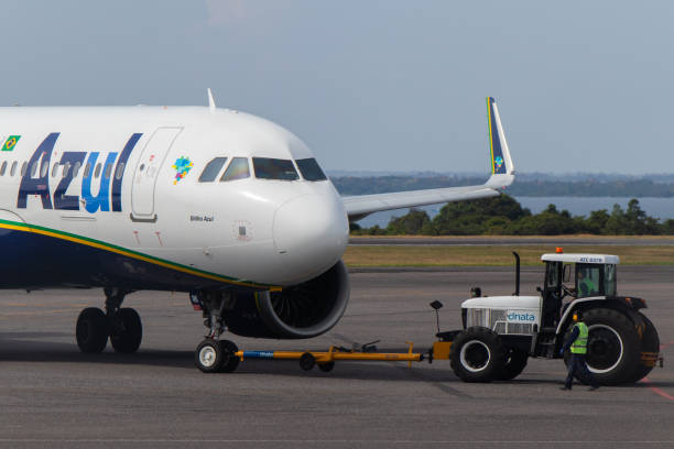 Pushback service on a Azul Brazilian Airlines aircraft performed by a Dnata tractor at Santarem Airport (SBSN) Pushback service on a Azul Brazilian Airlines aircraft performed by a Dnata tractor at Santarem Airport (SBSN) stm photos stock pictures, royalty-free photos & images