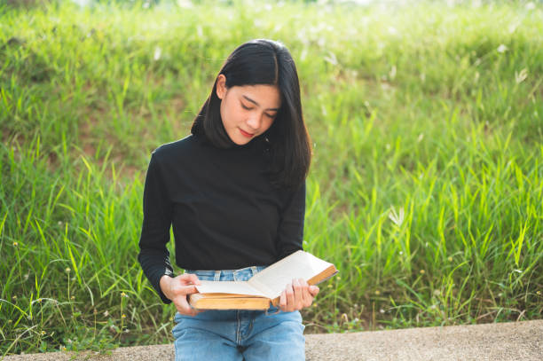 istock Beautiful young students open books to read at the university. 1169754164