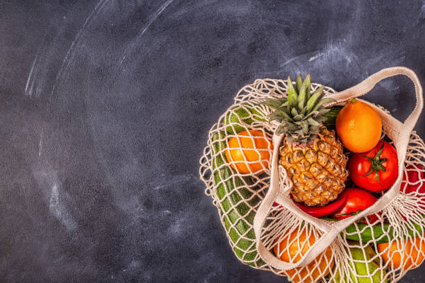 istock Fresh vegetables and fruits in bag mesh 1169755450