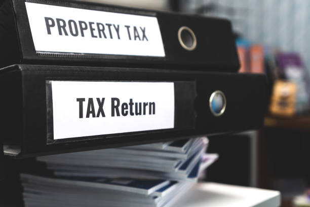 istock Tax return and property tax folders stack with label on black binder on paperwork documents summary report in busy offices. HR-human resources business bookkeeping accountancy Document Reports Concept 1169755668