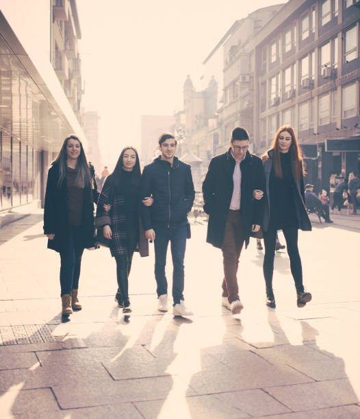 istock Five friends walking down the street 1169758351