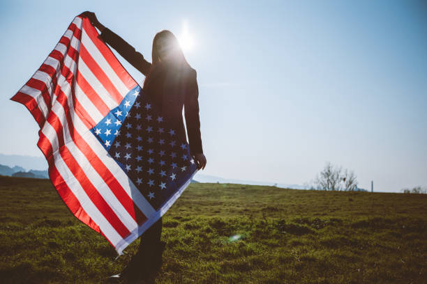 istock Young redhead spreading American flag 1169758888