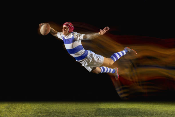 istock One caucasian man playing rugby on the stadium in mixed light 1169759069