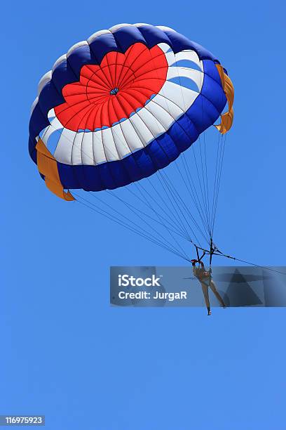 A Person Parasailing In A Big Blue Sky Stock Photo - Download Image Now - Airborne Sport, Blue, Color Image