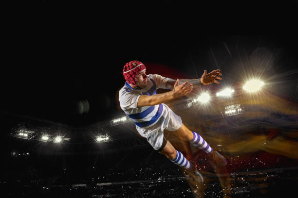 Ready to fly for win. One caucasian man playing rugby on the stadium in mixed light. Fit young male player in motion or action during sport game. Concept of movement, sport, healthy lifestyle.