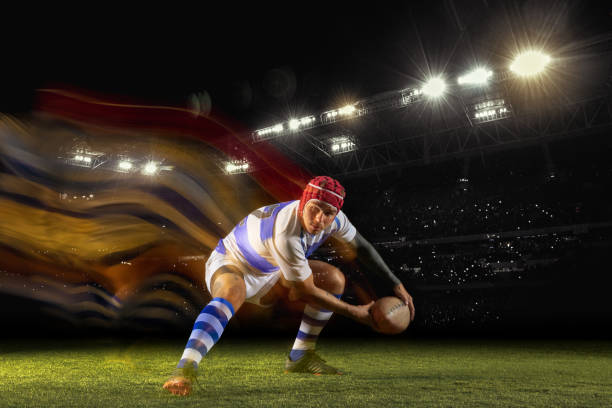 istock One caucasian man playing rugby on the stadium in mixed light 1169759576