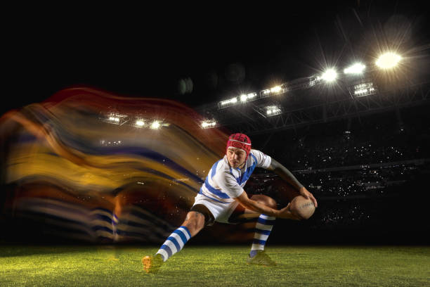 istock One caucasian man playing rugby on the stadium in mixed light 1169759577