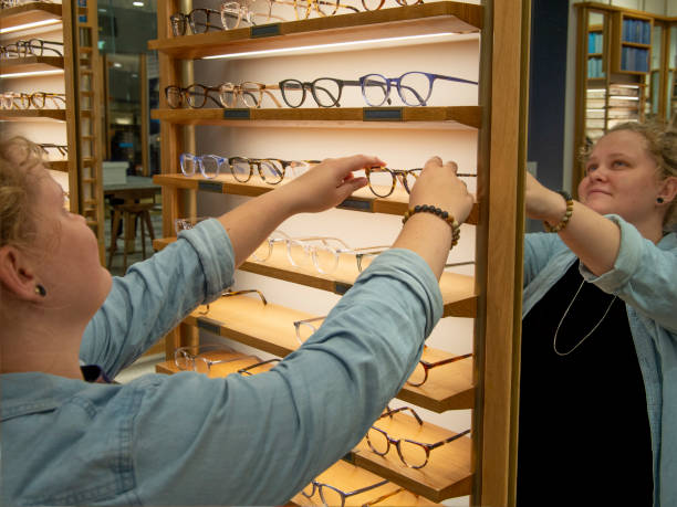 istock Woman trying on eyeglasses 1169759630