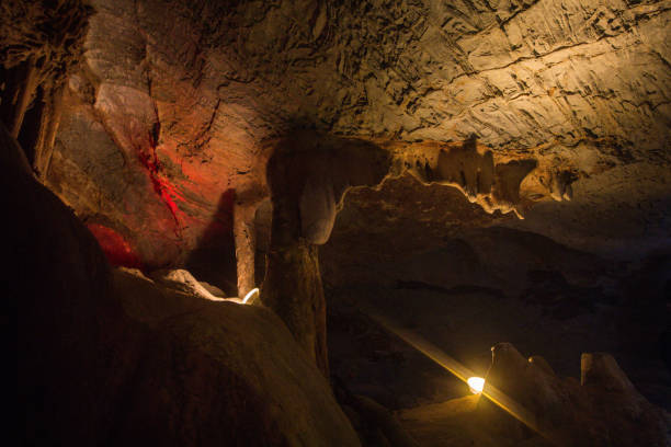 istock Stalactites and stalagmites illuminated by lights in a cave 1169759884