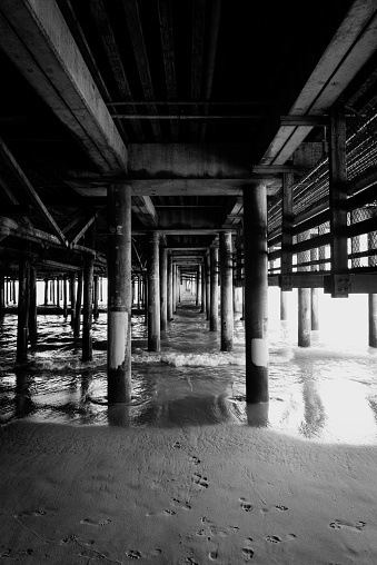 Black and white iew of the pylons of Santa Monica pier in Los Angeles USA