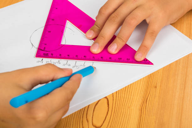 istock girl draws lines with a pencil using rulers 1169772597