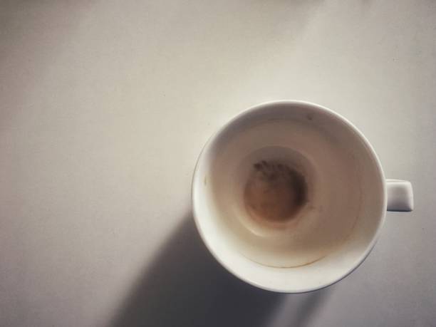 istock Empty cup with stain of hot coffee top view on white table background. 1169773032