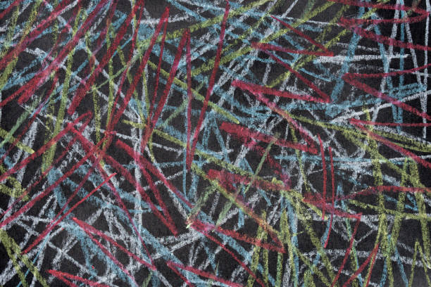 istock colorfull crayon doodles on black paper texture background 1169774263