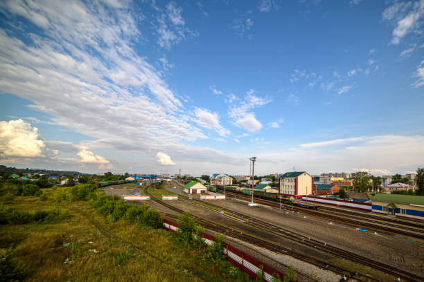 View of the railway tracks going into the distance. The sky before sunset with clouds