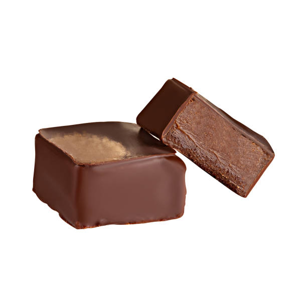 istock Cut luxury handmade candy with chocolate ganache isolated on white background 1169775081