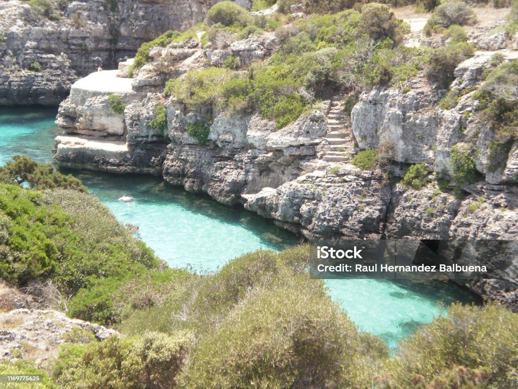 Beautiful Cala N Brush With Its Clear Waters Between Blue And Green In Citadel On The Island Of Menorca. Beautiful Cala N Brush With Its Clear Waters Between Blue And Green In Citadel On The Island Of Menorca. July 5, 2012. Xon Xoriguer, Citadel, Menorca, Balearic Islands, Spain, Europe. Travel Tourism Street Photography Balearic Islands Stock Photo