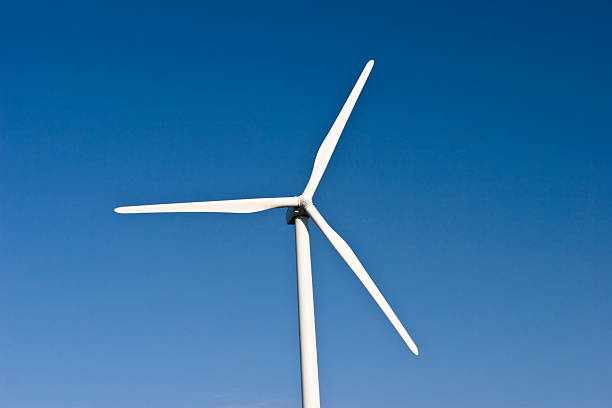 Wind turbines generating electricity or for water pump with sky background.