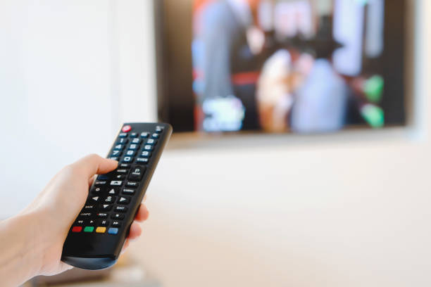 istock A hand pointing a remote control at the TV 1169787501