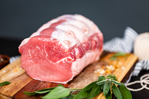 Uncooked boneless pork roast on the cutting board.