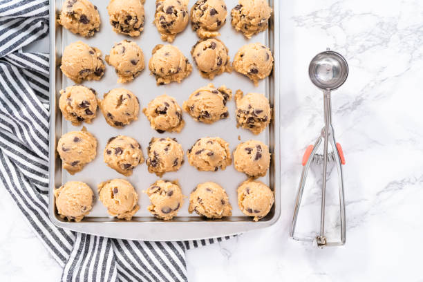 istock Homemade chocolate chip cookies dough scoops on a baking sheet. 1169792000