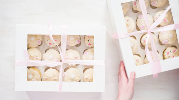 istock Boxing vanilla cupcakes in shape of Easter bunnies. 1169793034