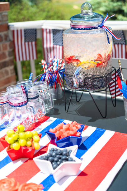 istock Table with food and drinks set for celebrating July 4th on the back patio. 1169793126