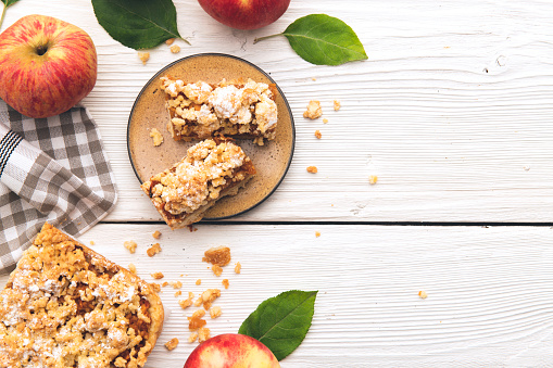 Baked traditional fruit cake on a white wooden table with space on text. top view